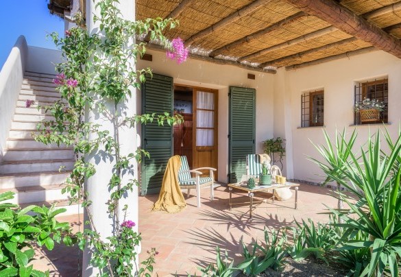 La zona living esterna ombreggiata dal portico adiacente alla camera e alla cucina - Villa Zaca