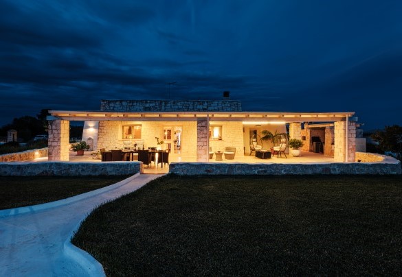 The exterior facade in the evening - White Stone House