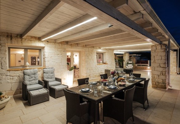 The outdoor dining table in the evening - White Stone House
