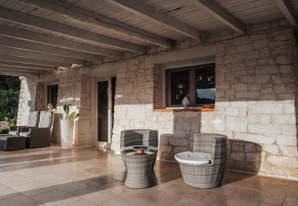 The outdoor sitting area next to the entrance. - White Stone House